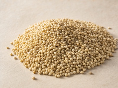 A heap of dehulled foxtail millet grain, pale golden straw-coloured kernels